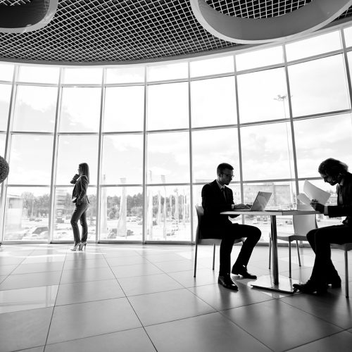 Working in office Two businessmen and businesswoman working in office